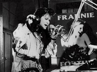 Nicole in the studio against a poster of her singing idol, Frannie Fortune